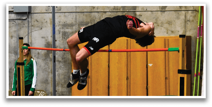A man is jumping over a barrier in a gym, wearing a black shirt and shorts. AI generated content