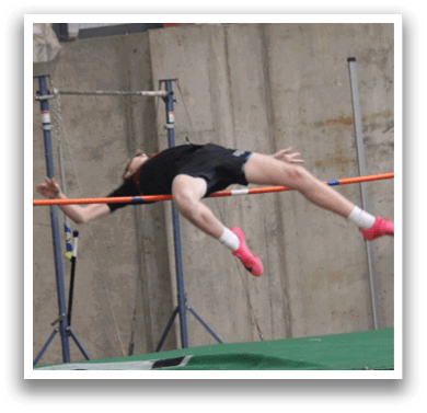 A man is jumping over a bar in a gym, wearing a black shirt and pink shoes. AI generated content