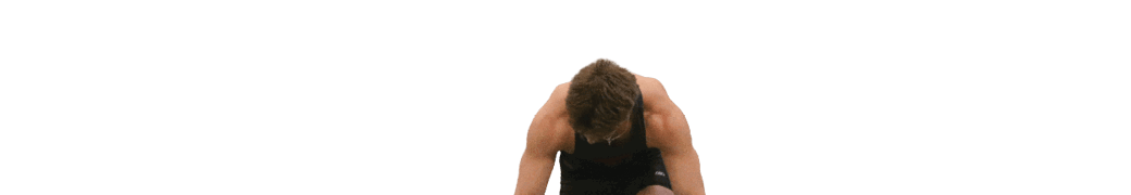 A man is bending over on a track. Description generated by AI