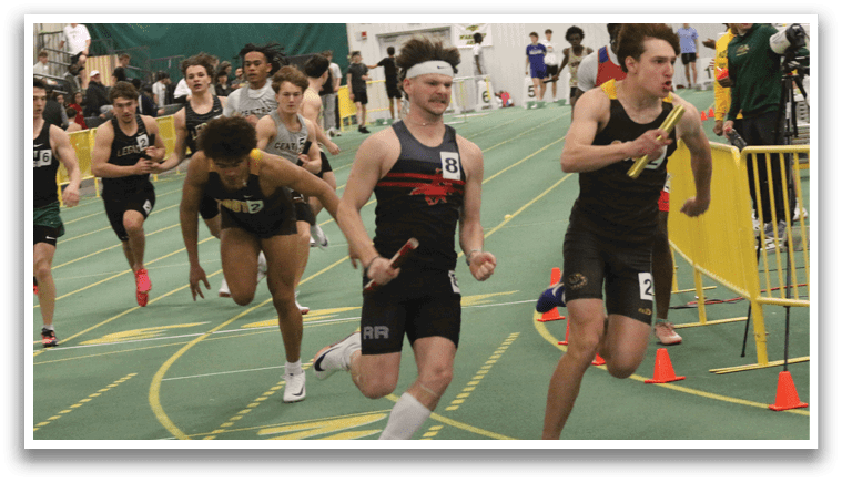 A group of people running on a track. Description generated by AI