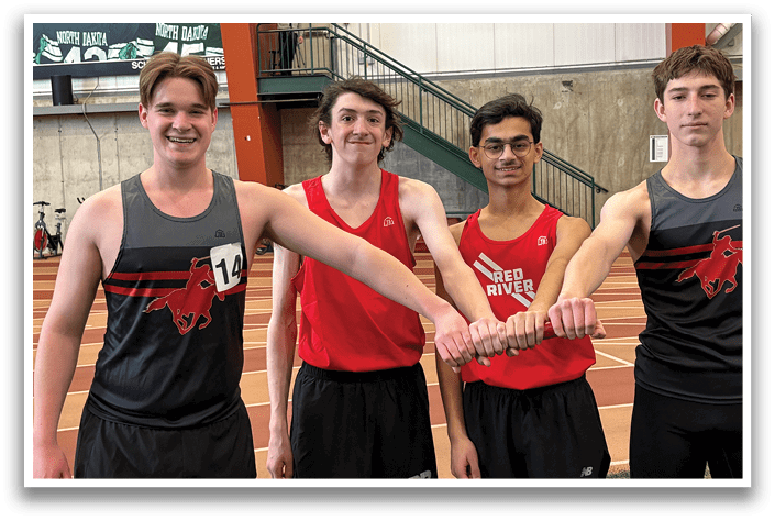 Four men wearing red and black shirts and shorts. Description generated by AI