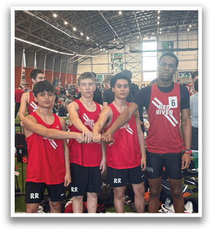 A group of young men wearing red shirts and black shorts pose for a picture. Description generated by AI