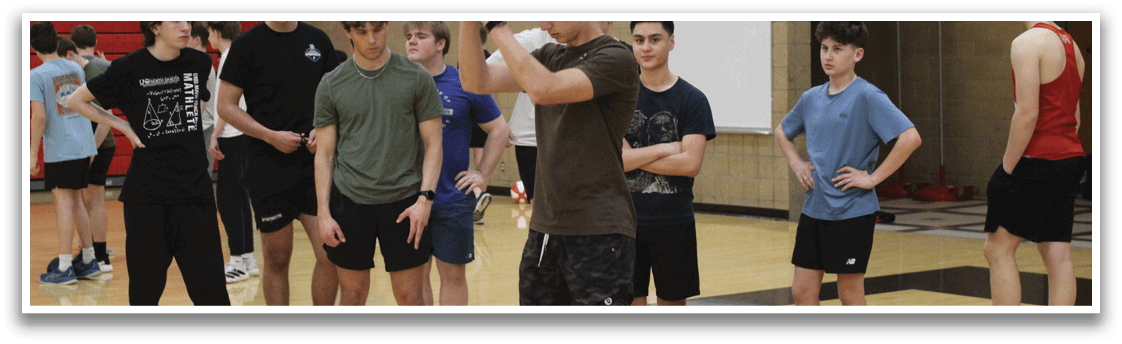 A group of young men in a gym. Description generated by AI