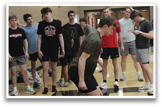 A group of men are standing in a gym. Description generated by AI