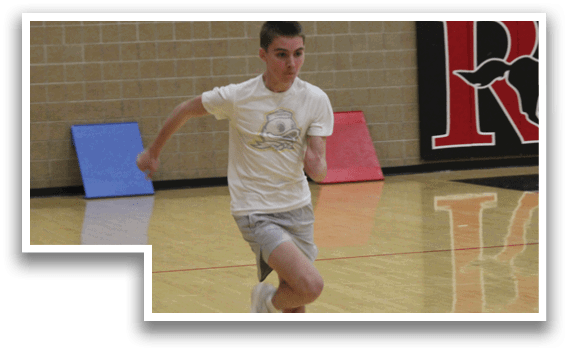 A man running on a gym floor. Description generated by AI