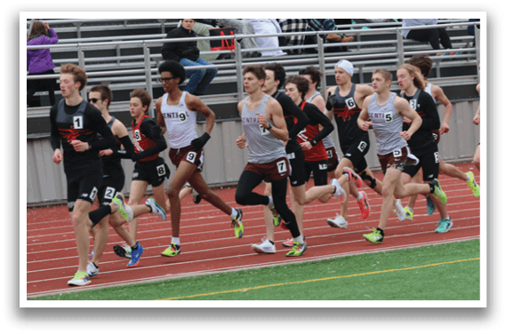 A group of people running on a track. Description generated by AI