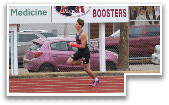 Two men running on a track. Description generated by AI