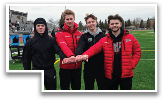 Four men wearing red and black jackets and black hats. Description generated by AI