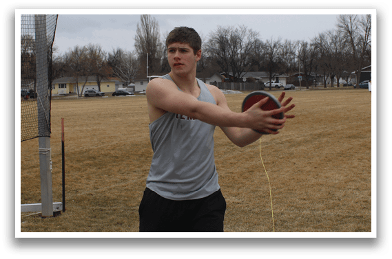 A man is holding a red frisbee. Description generated by AI