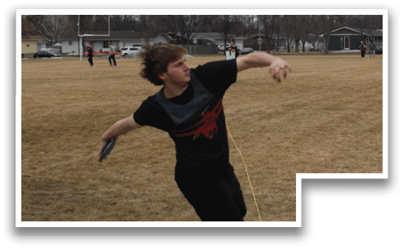 A man is throwing a frisbee in a field. Description generated by AI