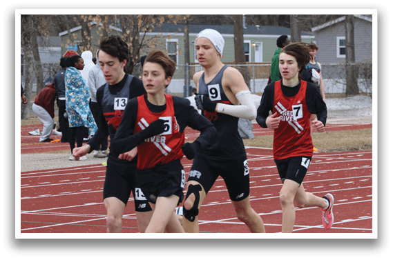 A group of young men running on a track. Description generated by AI
