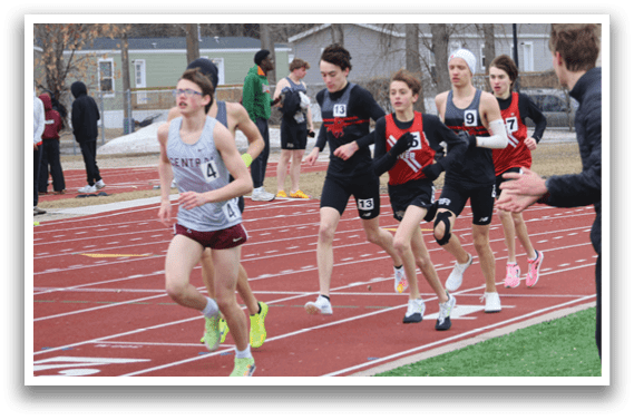 A group of people running on a track. Description generated by AI