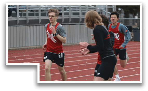 A group of people are playing a game of frisbee on a track. Description generated by AI