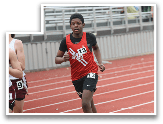 A boy running on a track with the number 133 on his shirt. Description generated by AI