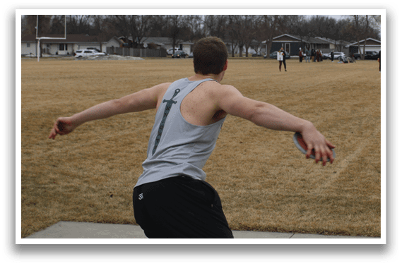 A man is throwing a frisbee in a field. Description generated by AI