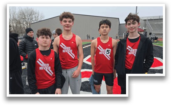 Four boys wearing red and black shirts and shorts. Description generated by AI