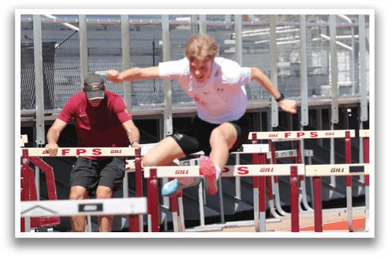 A man is running on a track with a red shirt. Description generated by AI