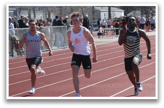 A group of runners on a track. Description generated by AI