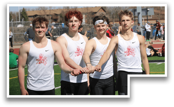 Five young men standing on a field. Description generated by AI