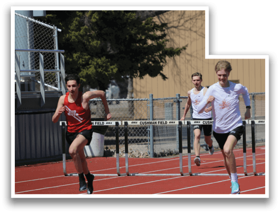 A group of men running on a track. Description generated by AI