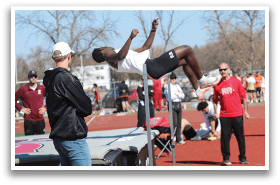 A man is jumping over a barrier. Description generated by AI