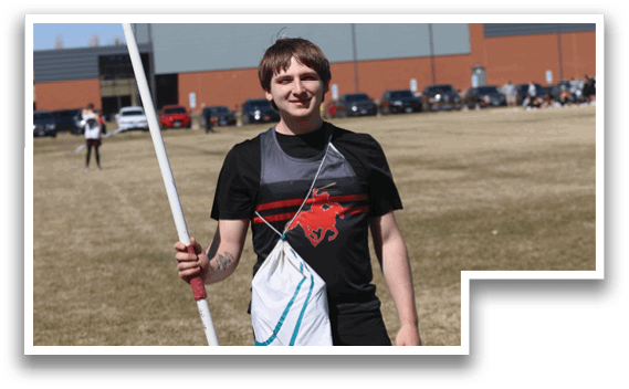 A man holding a red and white pole. Description generated by AI