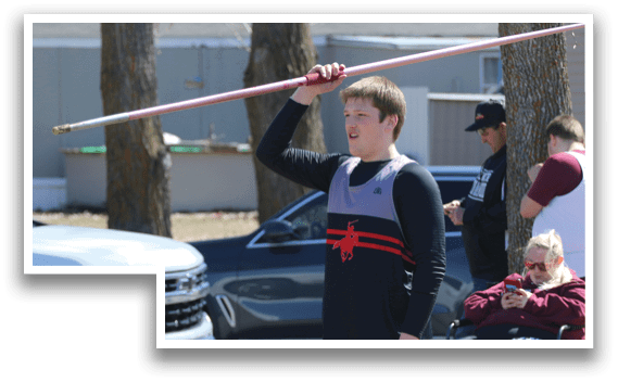 A man holding a red pole. Description generated by AI