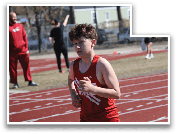 A boy running on a track. Description generated by AI