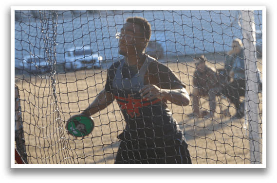 A man is throwing a green ball in a field. Description generated by AI