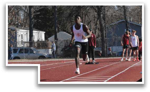 A man running on a track. Description generated by AI