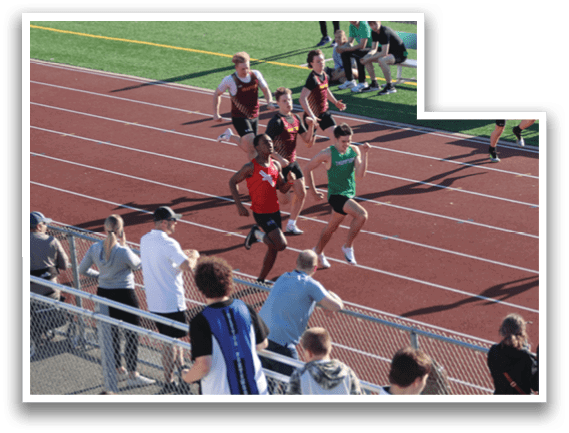 A group of people are watching a race on a track. Description generated by AI