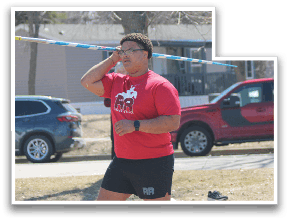 A man in a red shirt is holding a blue pole. Description generated by AI