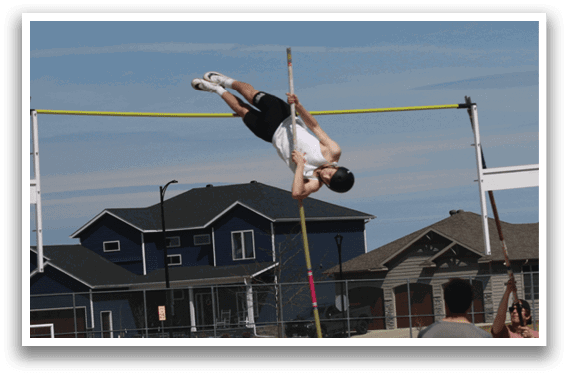 A man is jumping in the air over a pole. Description generated by AI