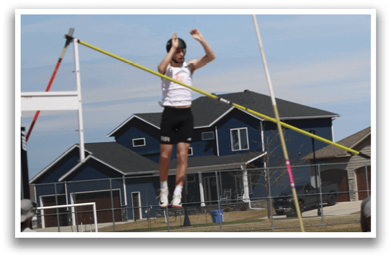 A man is jumping in the air to catch a pole. Description generated by AI