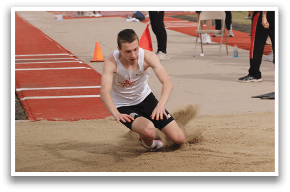 A man is sliding on the ground in a dirt track. Description generated by AI