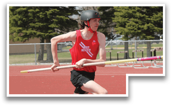 A man running on a track with a pole in his hand. Description generated by AI