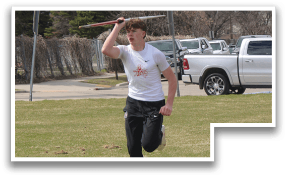 A man is holding a baseball bat in a field. Description generated by AI