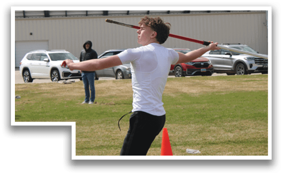 A man is holding a red pole and jumping in the air. Description generated by AI