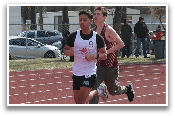 A boy running on a track. Description generated by AI