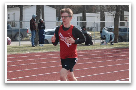 A man running on a track. Description generated by AI