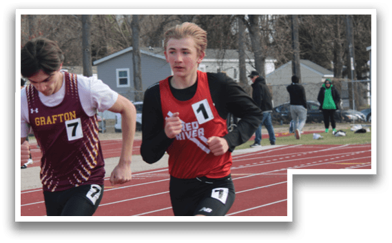 Two boys running on a track. Description generated by AI