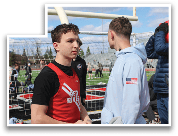 Two men wearing blue jackets and red shirts. Description generated by AI