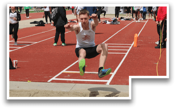 A man is jumping in the air on a track. Description generated by AI