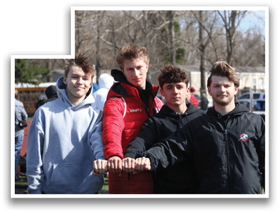 Four young men wearing black jackets and red jackets. Description generated by AI