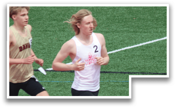 Two boys running on a field. Description generated by AI