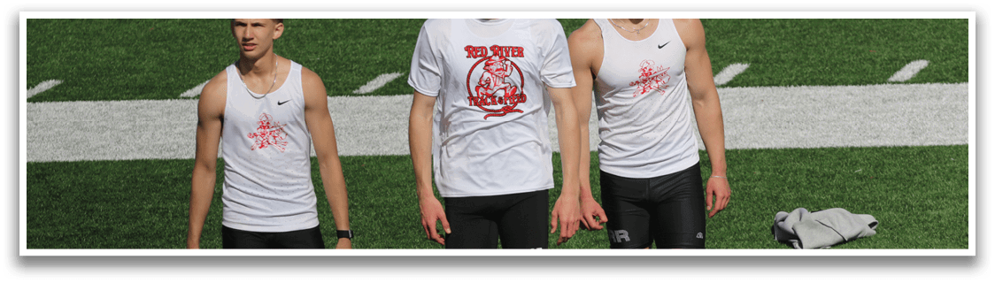 Three men wearing white shirts and black shorts are walking on a field. Description generated by AI