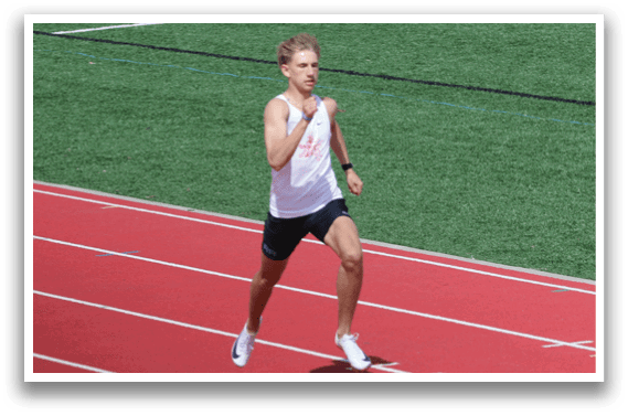 A man running on a track. Description generated by AI