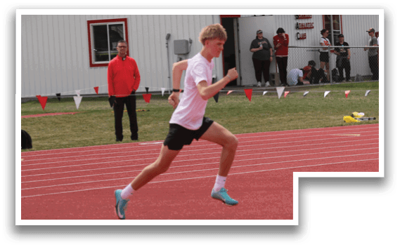 A man running on a track. Description generated by AI