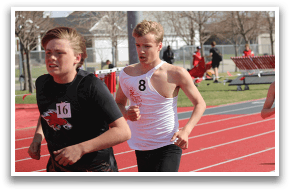 A boy running on a track with a number 16 on his shirt. Description generated by AI