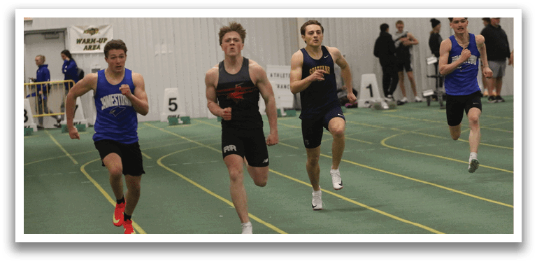 A group of young men running on a track. Description generated by AI